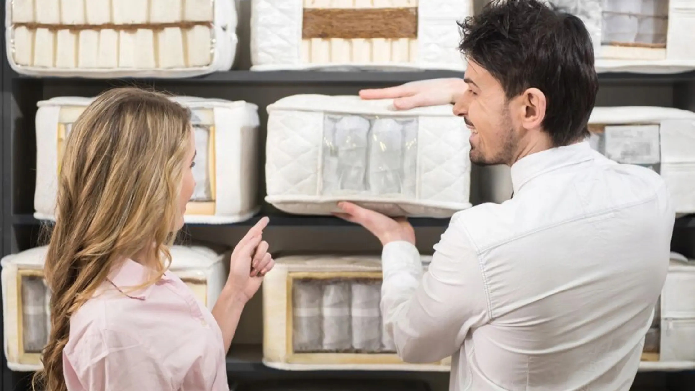 A man and a woman looking at laundry wash and fold and discussing laundry cost.